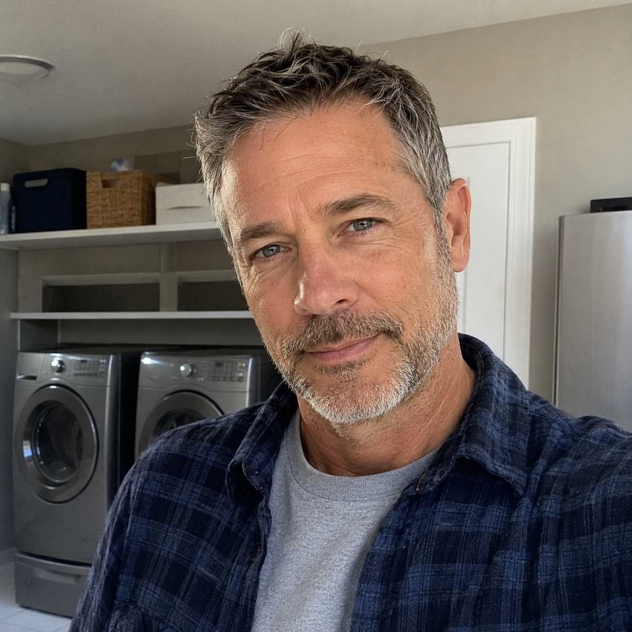 Daniel Brooks in a home laundry area with modern appliances